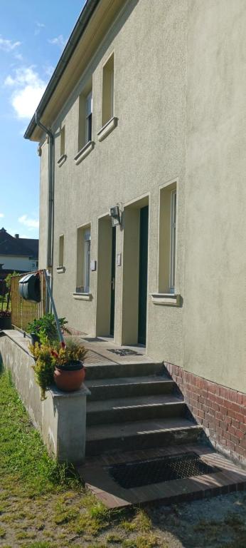 a building with stairs and plants in front of it at Lausitzer Auszeit in Laubusch