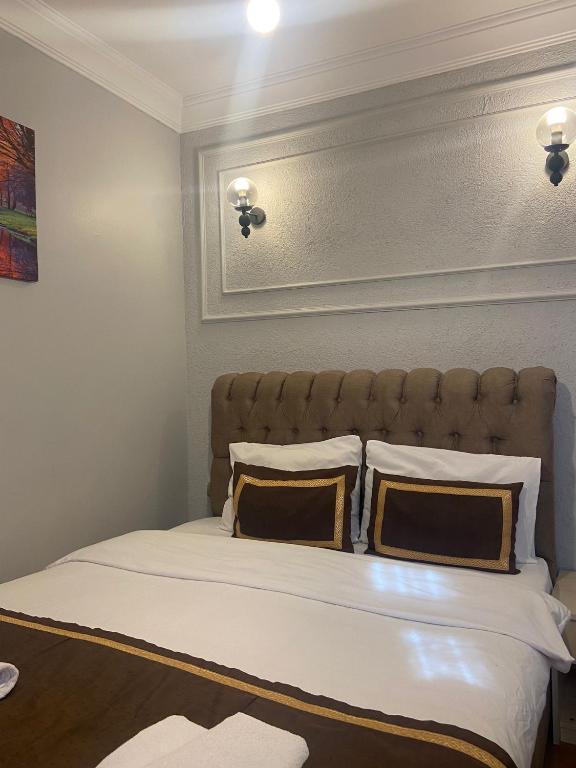 a bedroom with a large bed with two pillows at Divan Wooden Guesthouse in Istanbul
