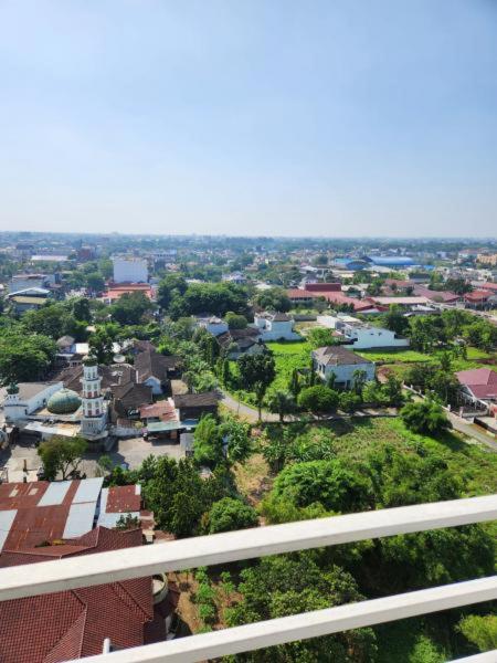 a view of a city from a balcony at Khodijah Homestay in Medan