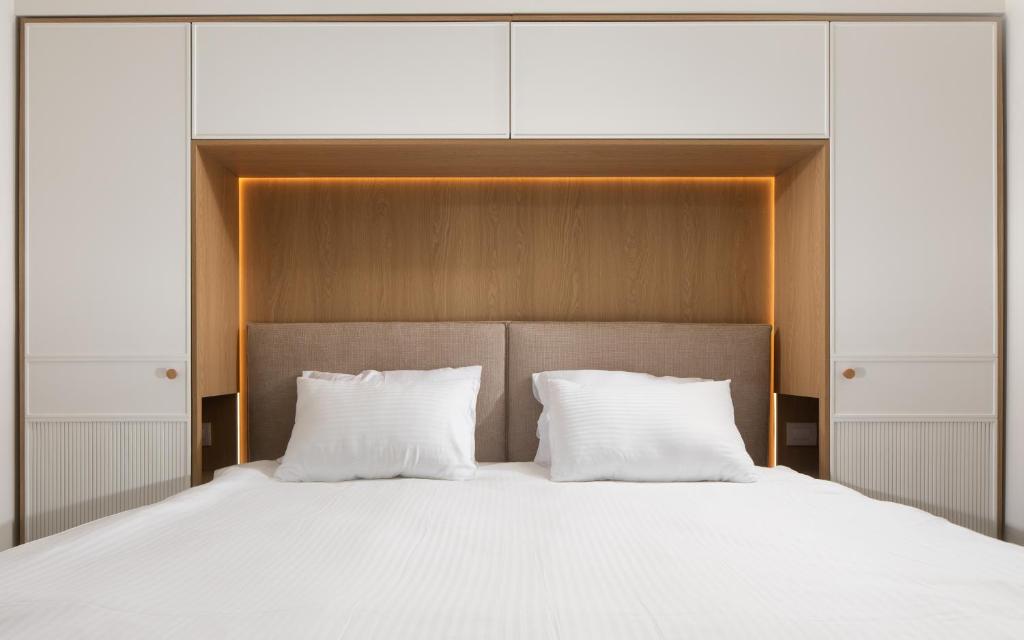 a large bed with two white pillows at סי סייד - אביה סונסטה in Eilat