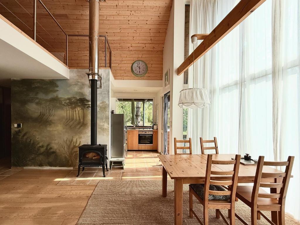 a kitchen and dining room with a table and a fireplace at 4borovice in Velká Lečice