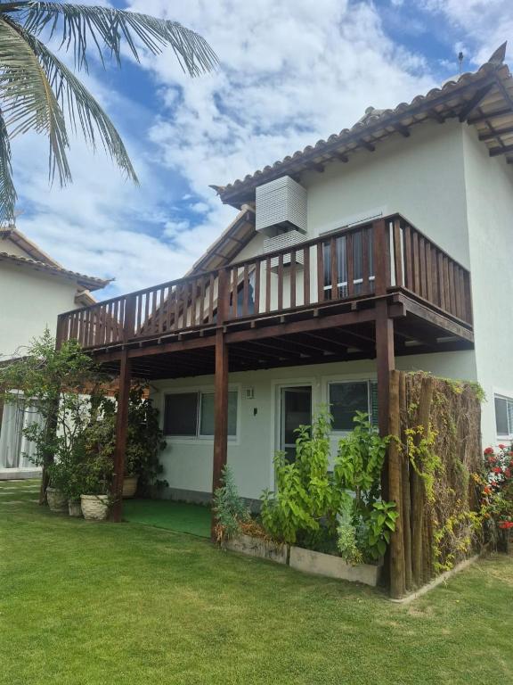 a house with a deck on top of it at Buzios Inn in Búzios