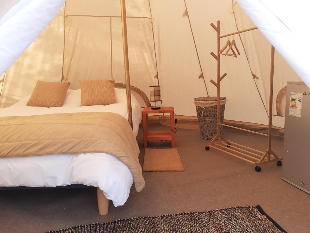 una camera da letto con un letto in una tenda di Achibueno Glamping a Linares