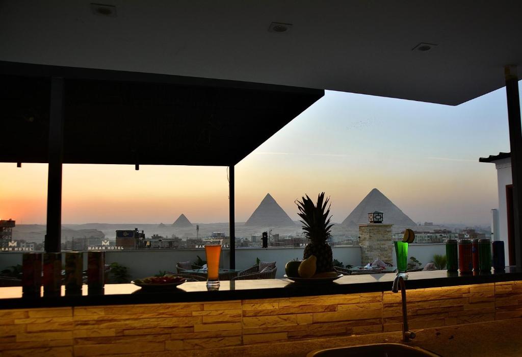 a bar with a view of the pyramids at Makan Pyramids Hotel in Cairo