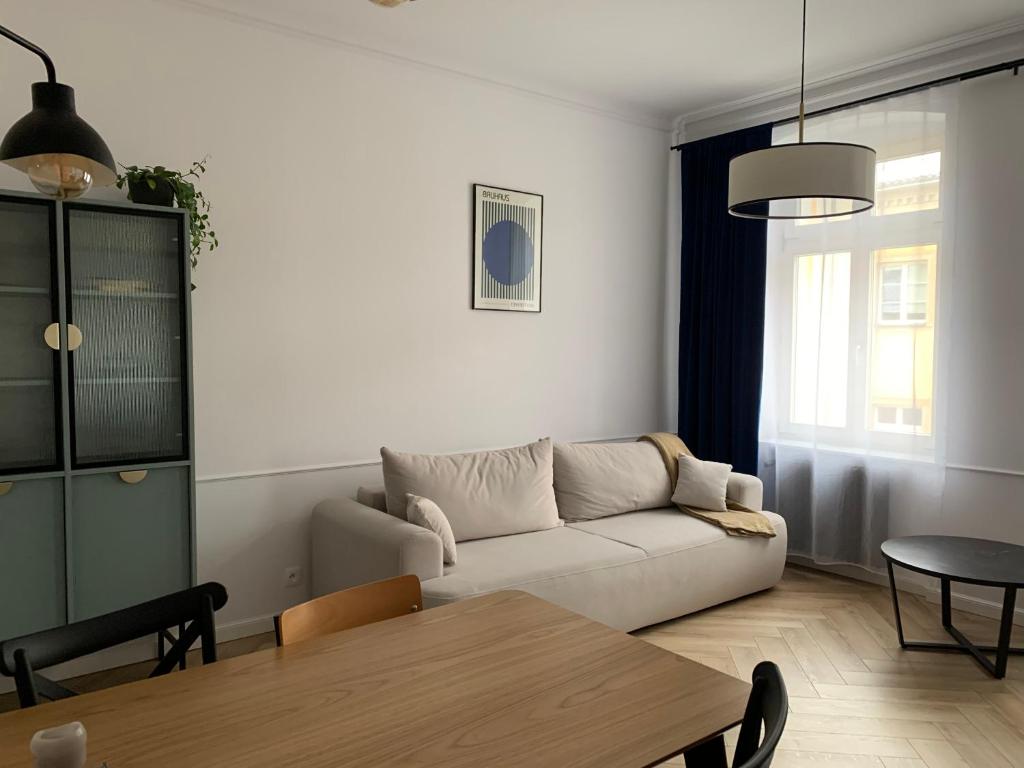 a living room with a couch and a table at Moon Deer in Jelenia Góra