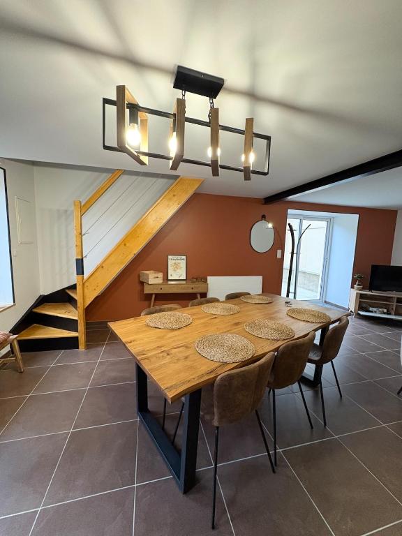 a dining room with a large wooden table and chairs at Escapade à Pierry in La Celle-sous-Gouzon