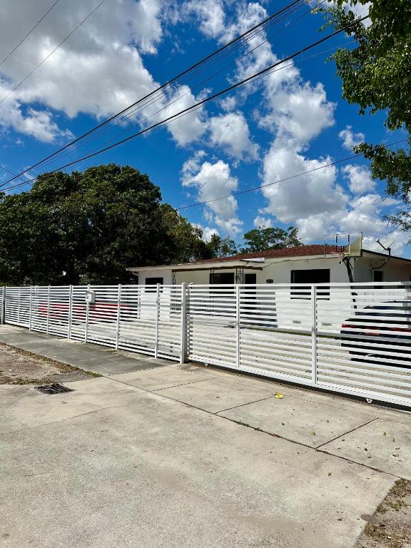 a white fence in front of a house at 2 bedroom 2467 in Miami