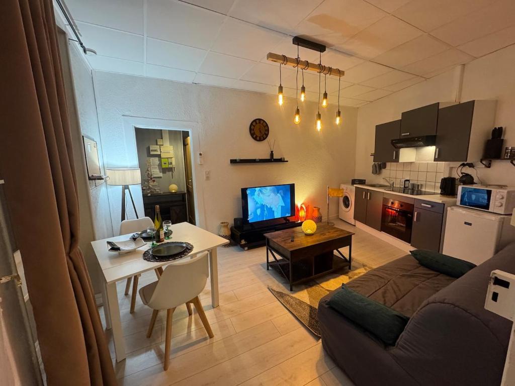 a living room with a couch and a table at Studio de la Doller in Masevaux