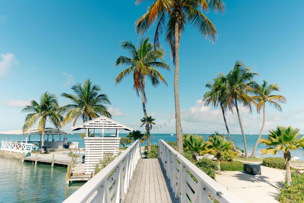 a bridge over the water with palm trees and the ocean at Casa Morada in Islamorada