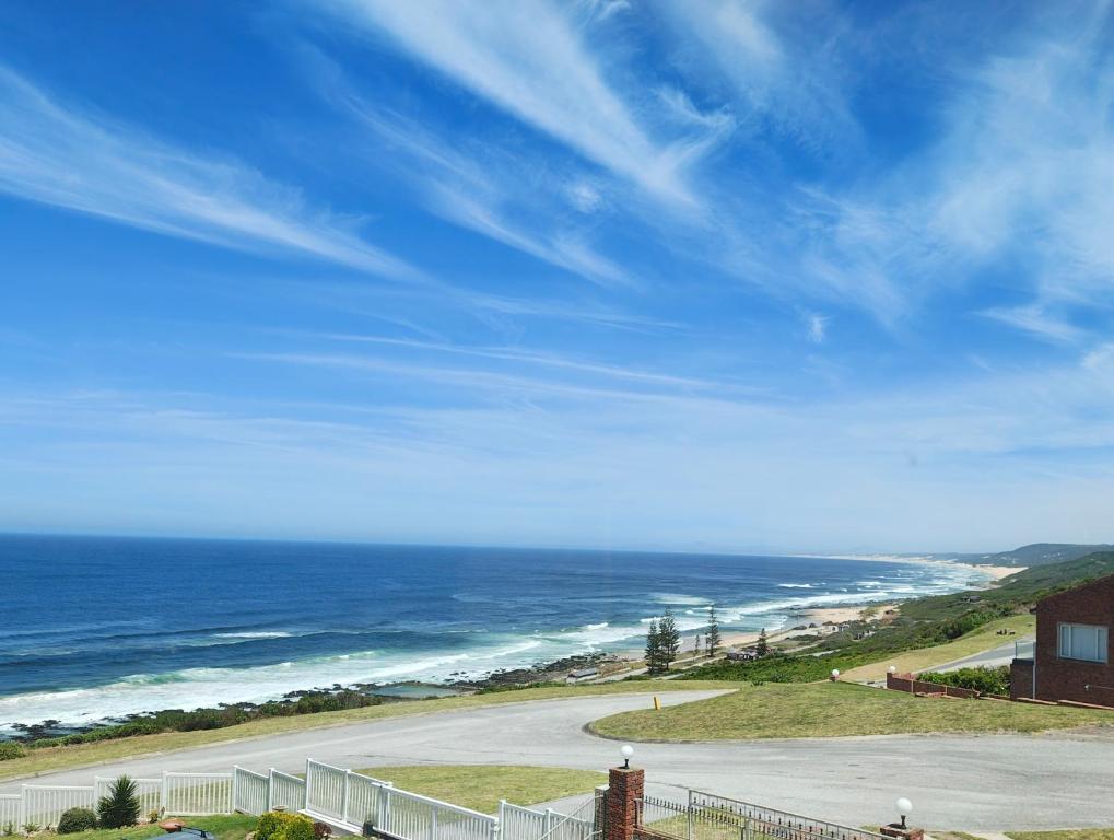 a view of the ocean with a fence and a road at Swallow's Beach in Port Elizabeth