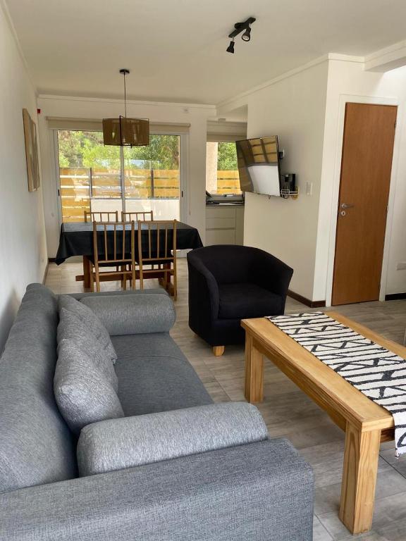 a living room with a couch and a table at Duplex del Parque y Balneario in Necochea