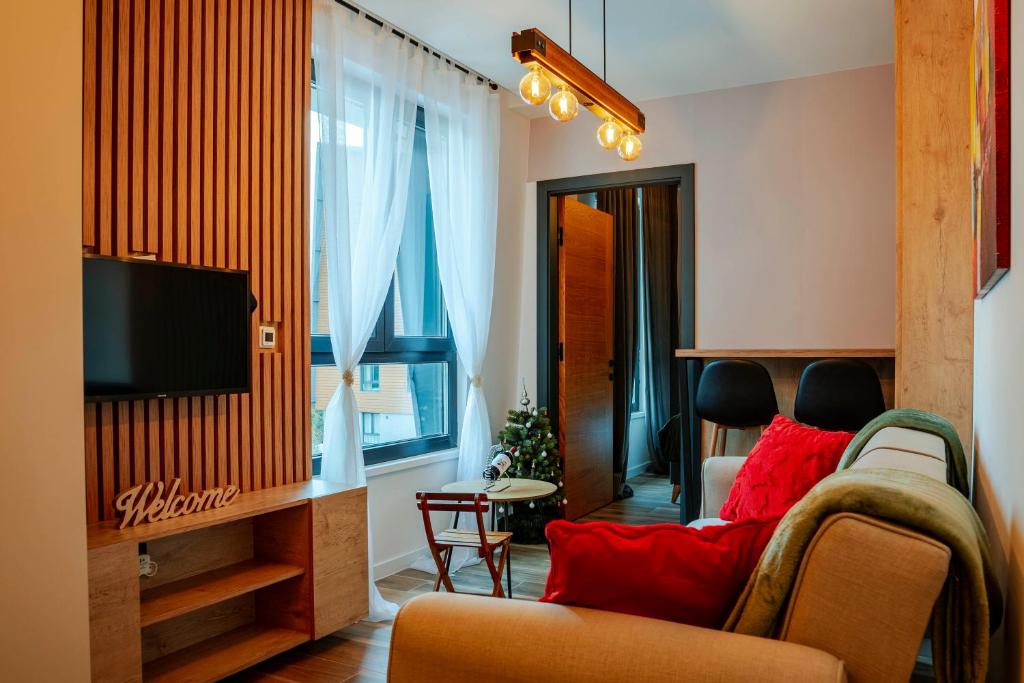 a living room with a couch and a tv at Sky Lux Cozy Nest in Jahorina