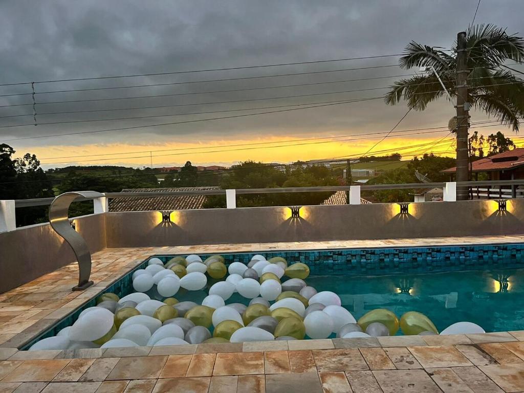 a swimming pool with a bunch of balls in it at Pôr do Sol - Atibaia in Atibaia
