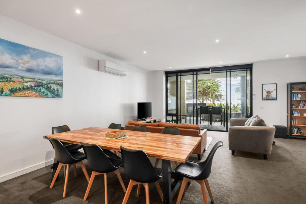 a dining room with a wooden table and chairs at Cscape3 in Cowes