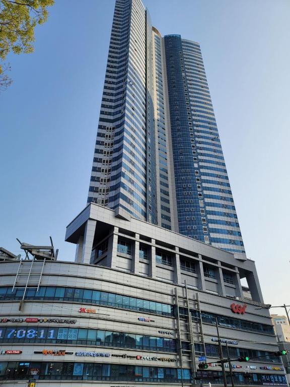 a tall skyscraper with a sign on it at W Residence Hotel in Busan