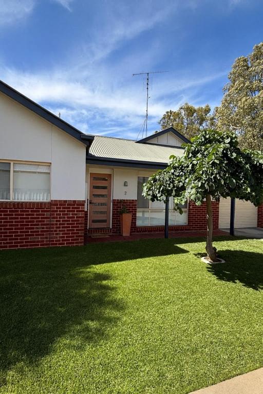 a house with a tree in the front yard at The Terrace - Echuca in Echuca