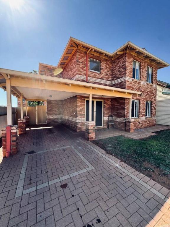 a house with a large patio in front of it at Live, Laugh, Lodge - Central 3x2 in Kalgoorlie