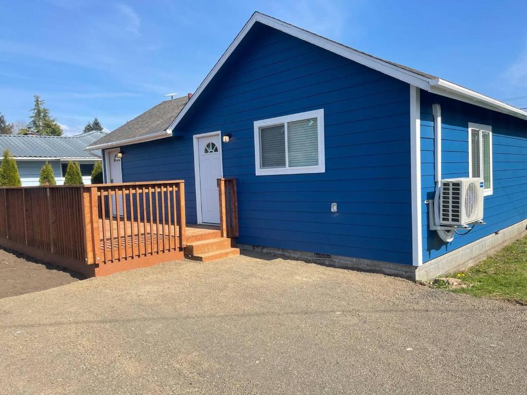 a blue house with a white door and a porch at Bogachiel Den in Forks