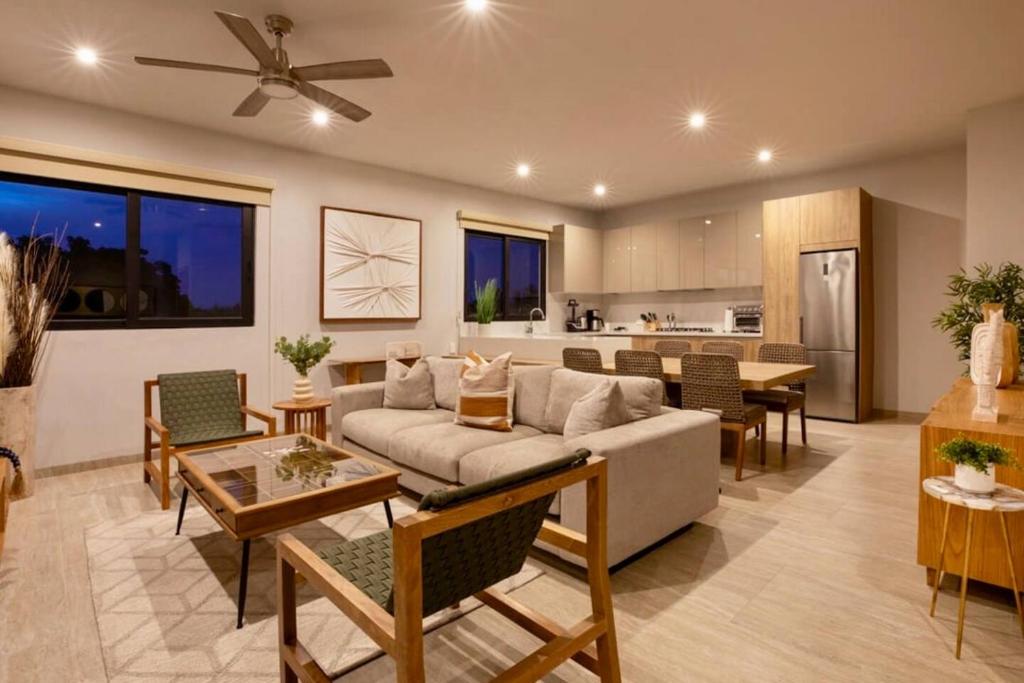 a living room with a couch and a kitchen at CASA 1111 SMALL in Mazatlán