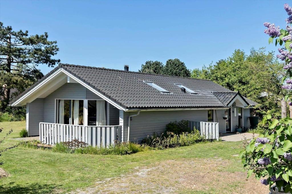 a small house with a fence in a yard at 1054-Stege-Ternevej-14 in Stege