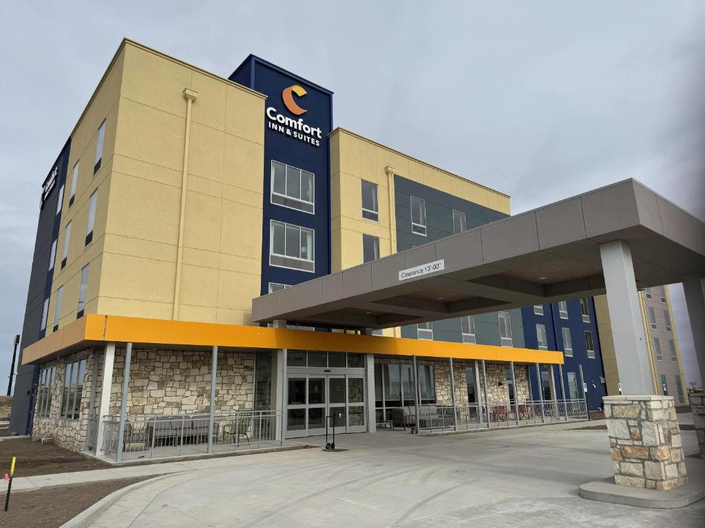 a large building with a sign on the side of it at Comfort Inn & Suites Colby in Colby