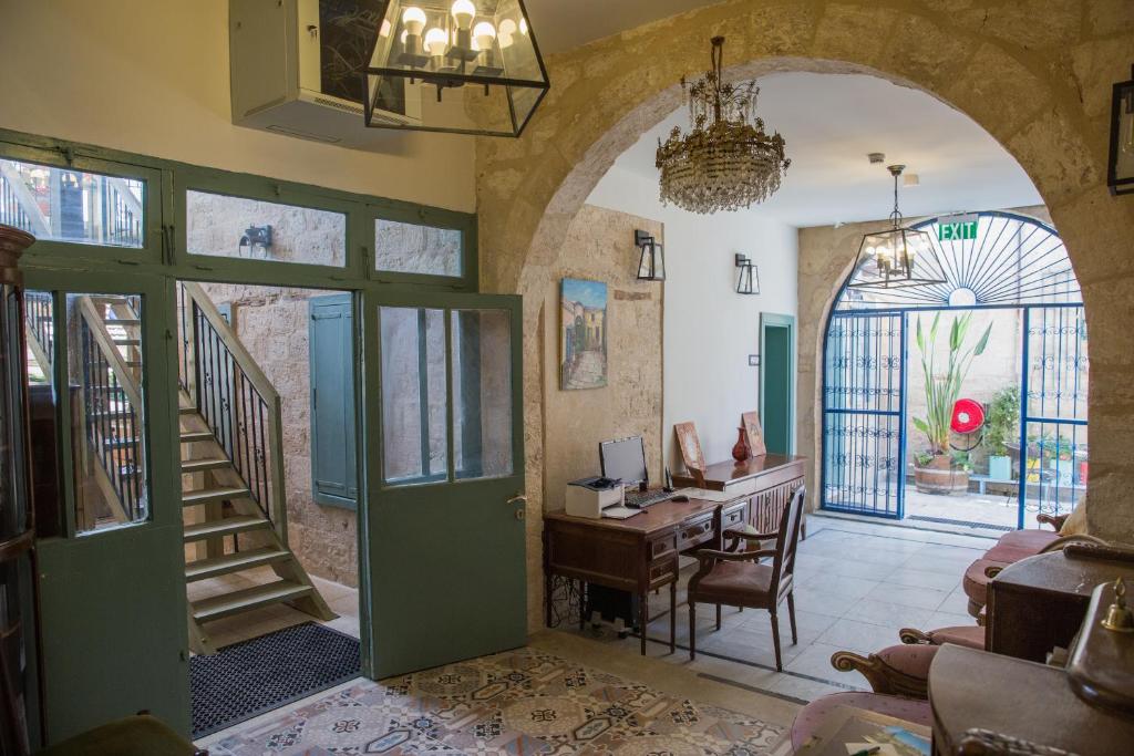 an entrance to a home office with a green door at Michel House in Nazareth