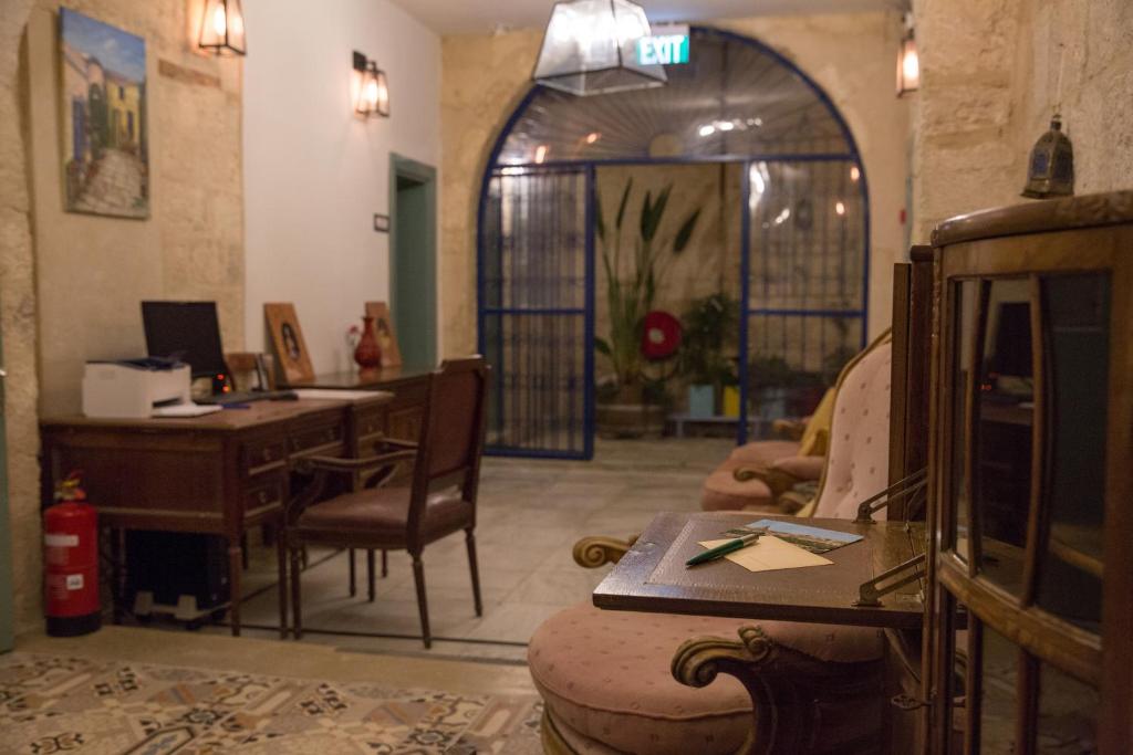 a living room with a desk and a computer in it at Michel House in Nazareth
