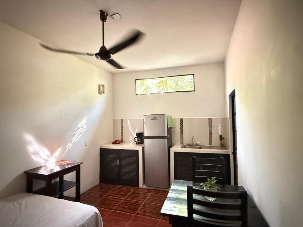 a kitchen with a refrigerator and a table in a room at Casa Roca in Zipolite