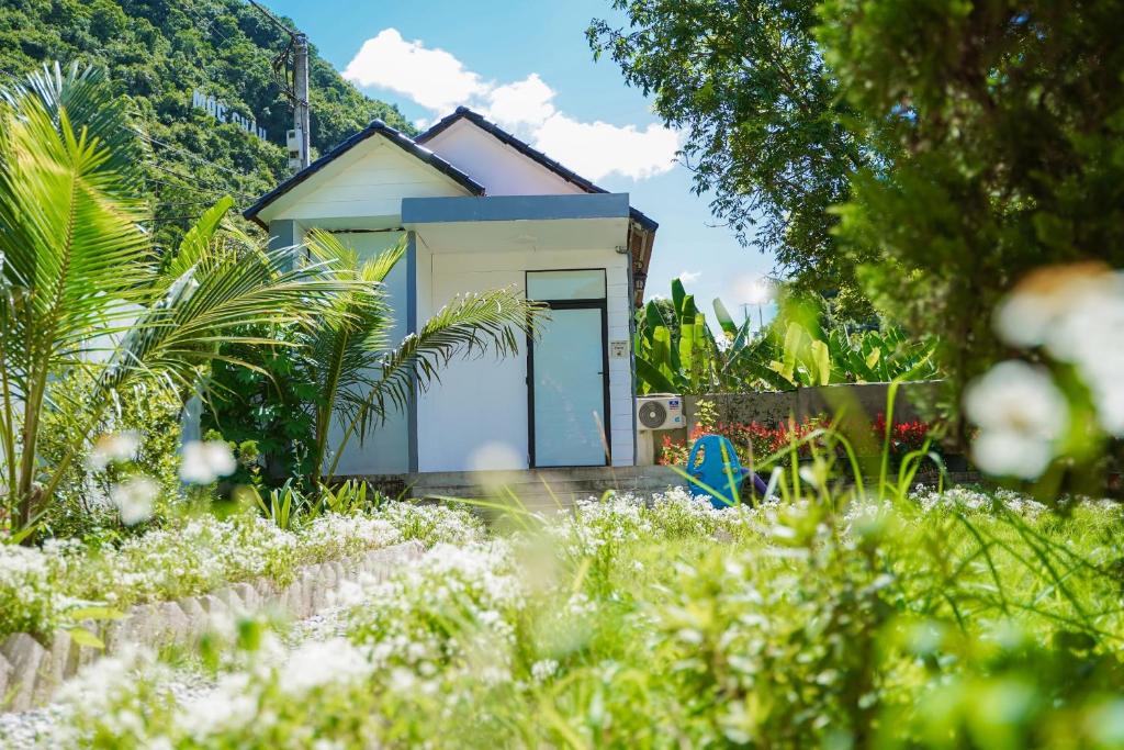 a tiny house in the middle of a garden at Mộc Châu House in Mộc Châu