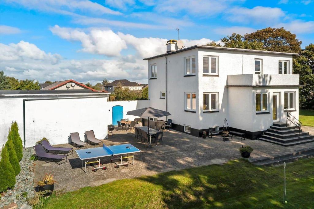 an aerial view of a white house with a patio at OH240-Hadsund-Thaliavej-3 in Hadsund