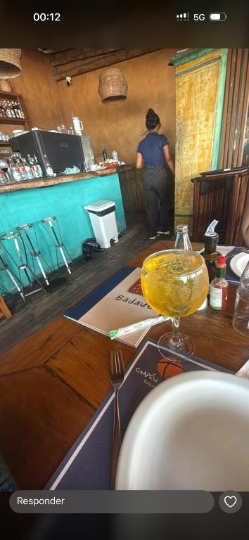a person standing at a table in a restaurant at Casa bosque in São Paulo