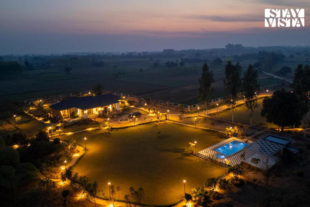 an overhead view of a large pool at night at StayVista at Treeansh with Pool, Lawn in Mohali