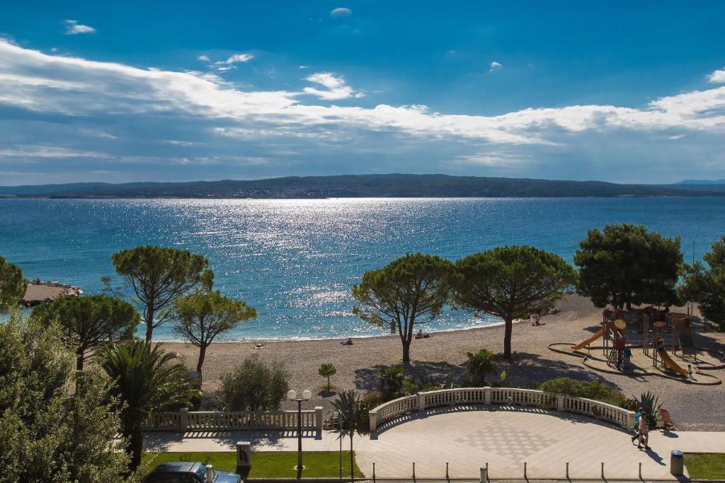 a view of a beach with trees and the water at Beach Apartments Center in Crikvenica