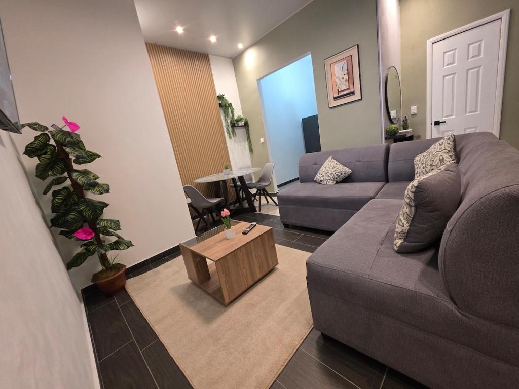a living room with a couch and a table at Confort en La Unión in La Unión