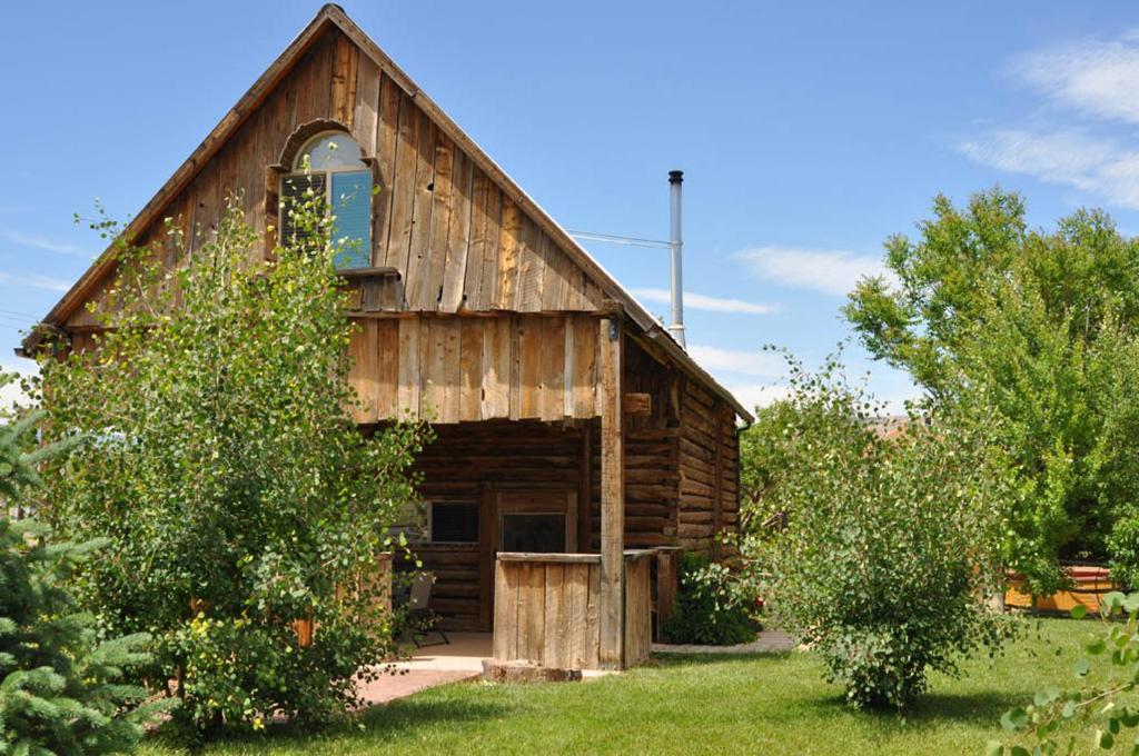 a wooden barn with a window on the side of it at Wild West Retreat in Escalante