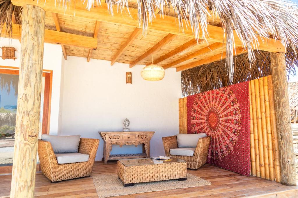 a patio with two chairs and a table and a table at Olas y Arena in Vichayito
