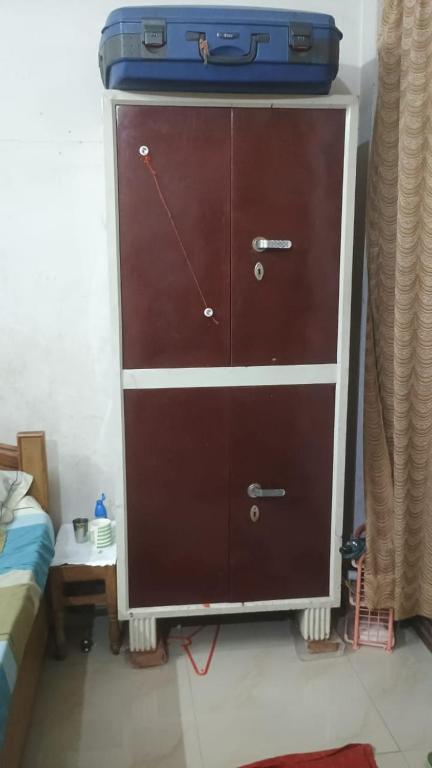 a dresser with a suitcase on top of it at josh poonam in Prayagraj