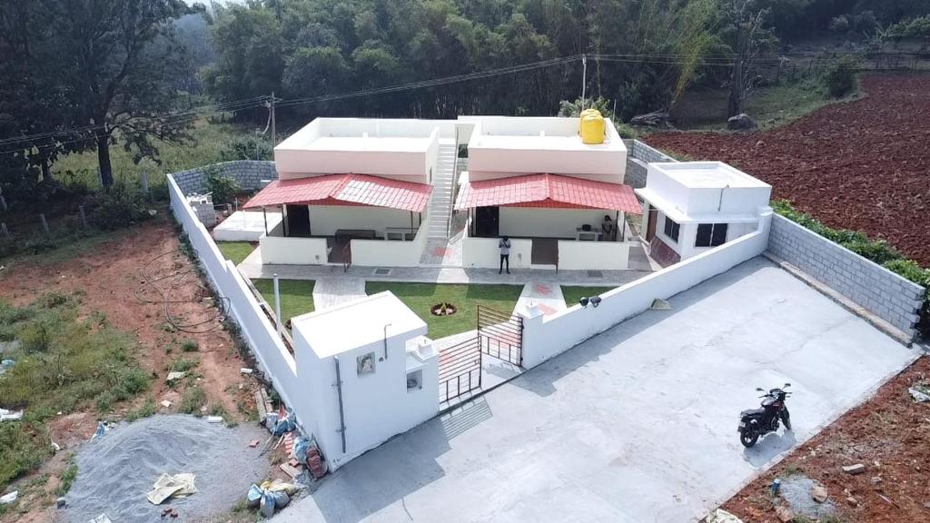 an aerial view of a house with a dog on the roof at Cheenu Cottage in Yelagiri