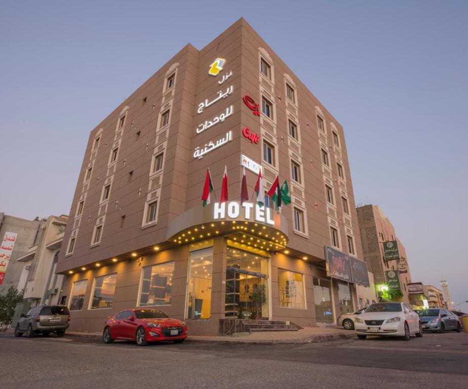 a hotel with cars parked in front of it at Retaj Hotel Apartments in Al Kharj