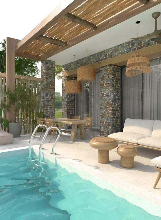 a patio with a swimming pool and a table and chairs at Casa Euphoria in Elounda