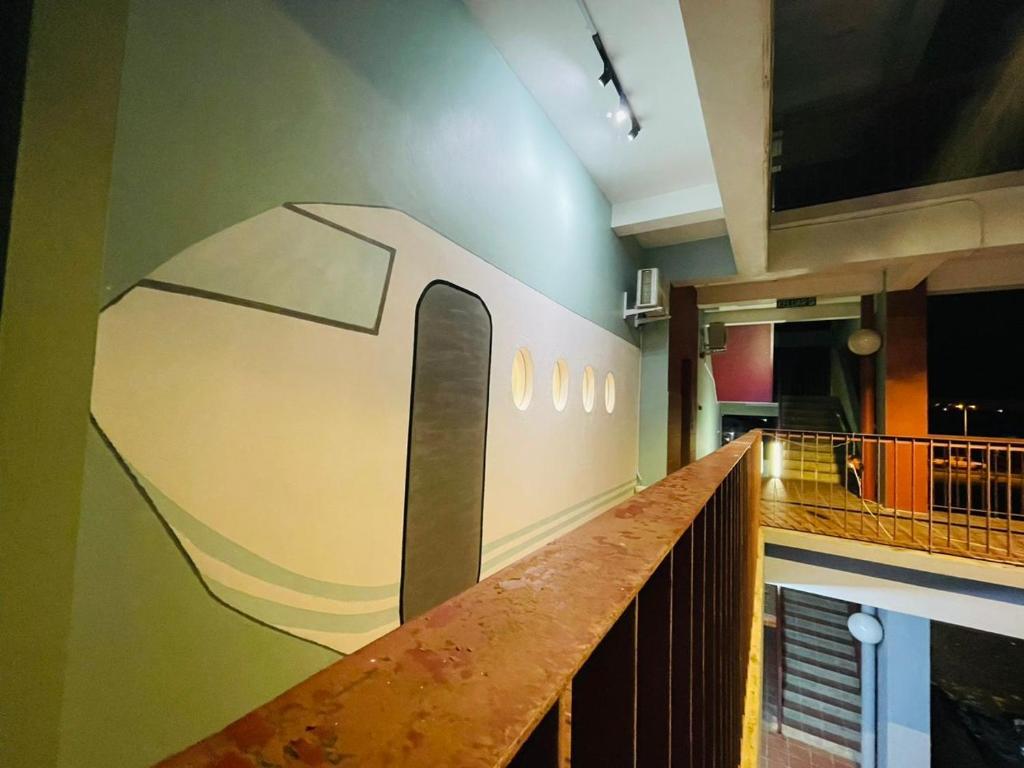 a hallway with a mural of a train on the wall at AeroHomesuites Tawau in Tawau