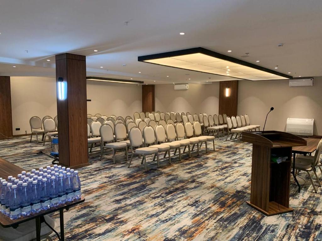 a conference room with chairs and a podium in it at Afrosiyob Regency Hotel in Stantsiya Kyzyl-Tukumachi