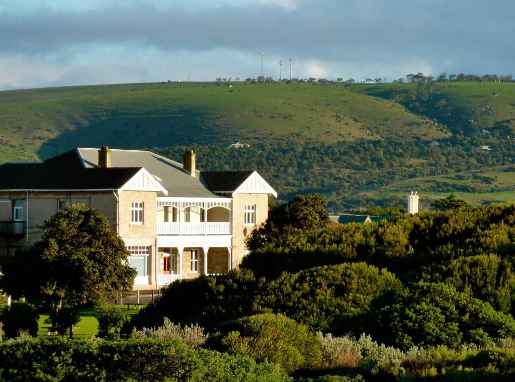 a house on top of a hill with trees at YHA Port Elliot Beach House in Port Elliot