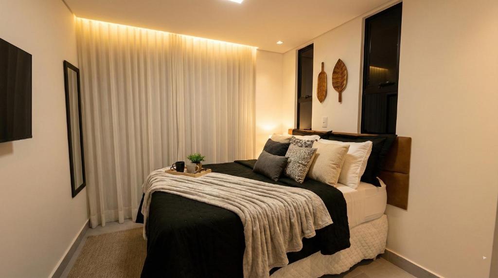 a bedroom with a bed with a blanket on it at Hit Cabo Branco Flat Aconchego a 30 metros do mar in João Pessoa