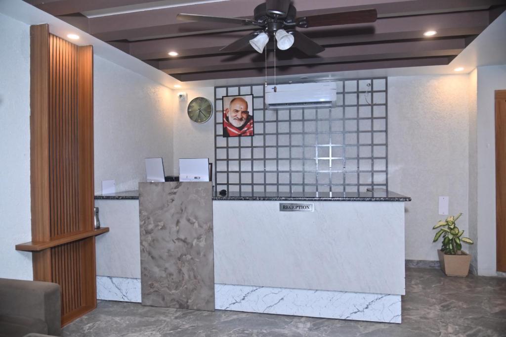 a bar with a picture of a man on the wall at Aarush Hotel & Resort in Haldwāni