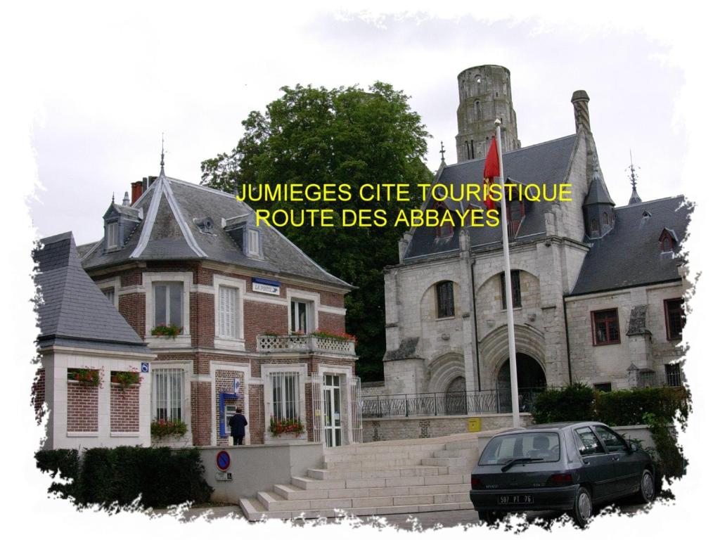 a house with a car parked in front of it at La Bonne Famille in Jumièges