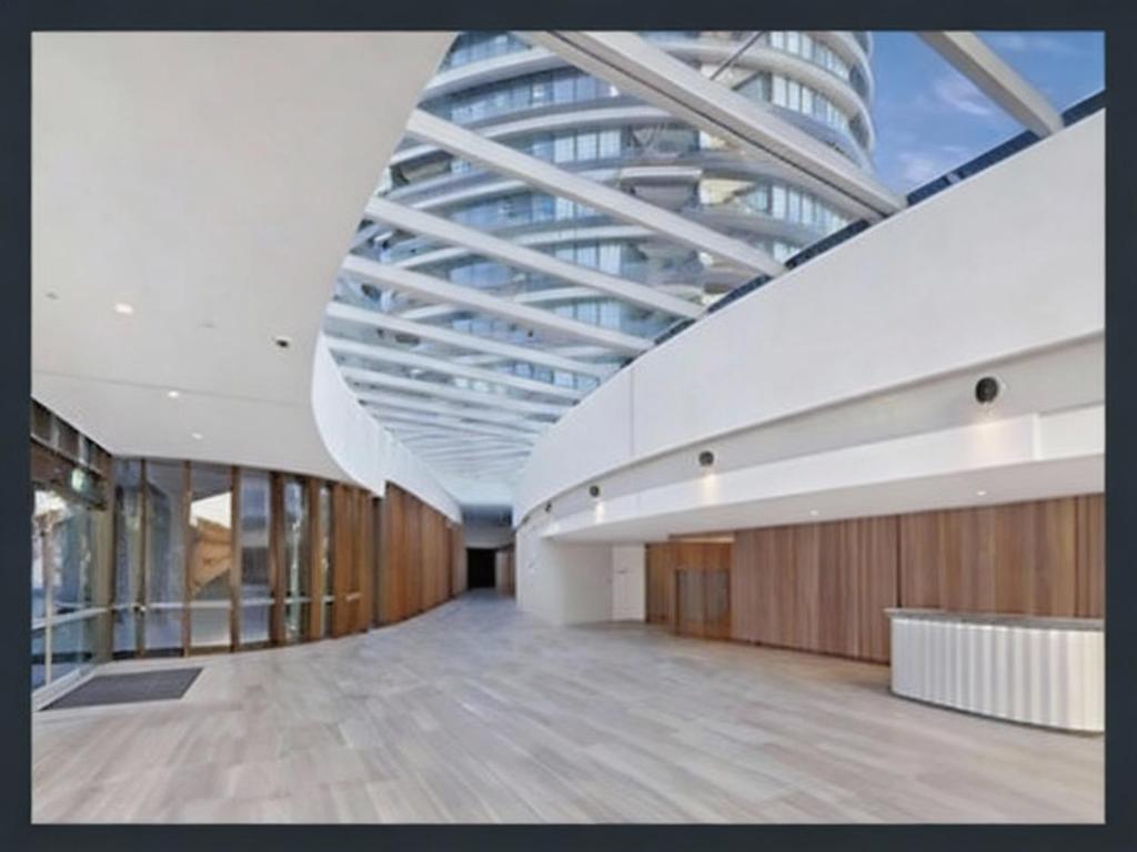 a large office building with a glass ceiling at Sydney Olympic Park 13Free Parking in Sydney