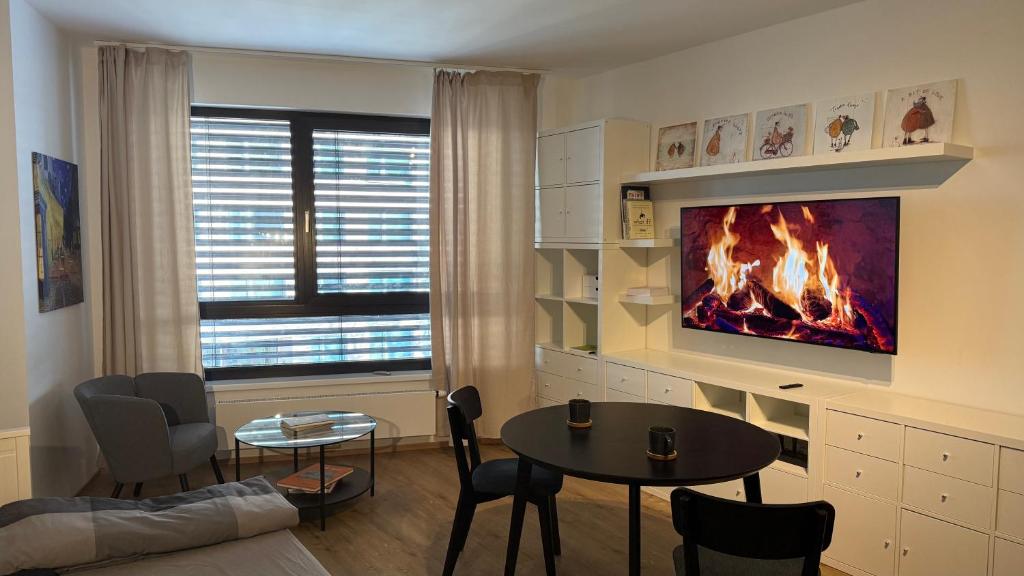 a living room with a table and a fireplace at NEW Stylish Prague Apartment VARTA ALPHA with Free Parking in Prague