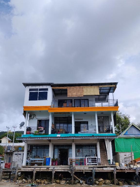 a tall building with balconies on a pier at Komodo Village Tour & Homestay in Komodo