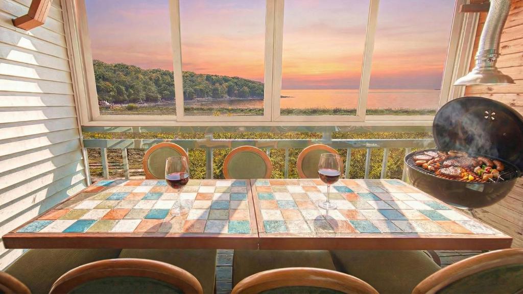 een tafel met twee glazen wijn voor een raam bij Ganghwa Ara Pension in Incheon